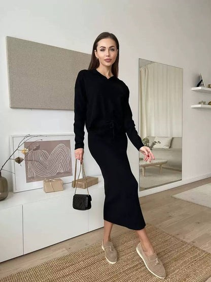 Knitted two-piece matching set with collared long sleeve top and drawstring midi skirt.